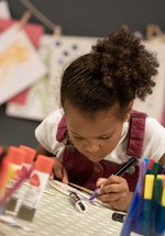 girl concentrates making a glider 