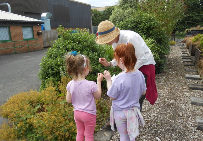 Children and adult in woodland walk area