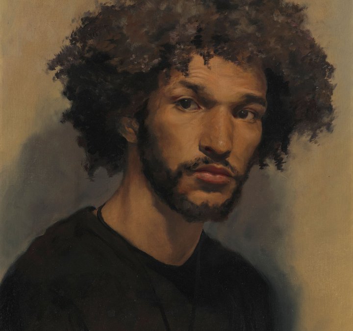 A portrait of a young man against a brown backdrop.