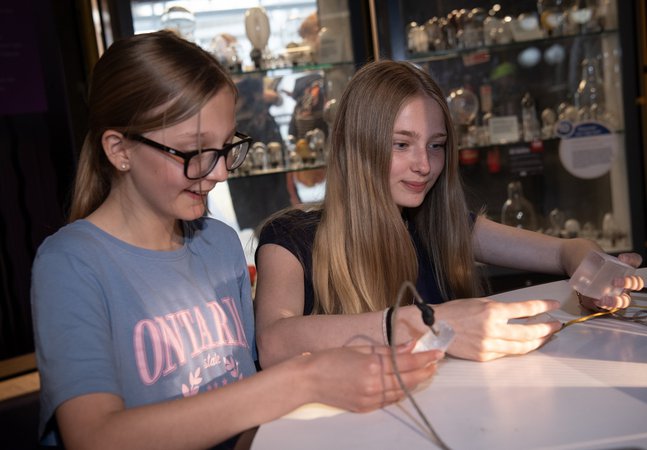 Two girls look at connections in the gallery 
