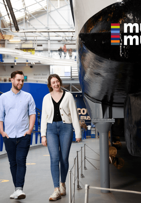 Two people walking through a museum