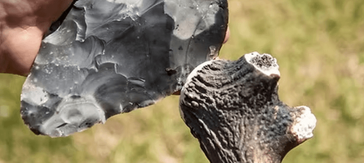 A persons hand are Flintknapping.
