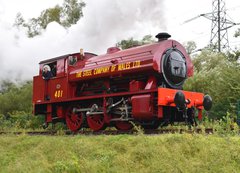 Red steam locomotive on railway track
