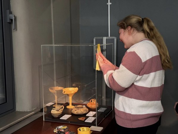 Emily adding the vinyl to the display case Emily adding the vinyl to the display case
