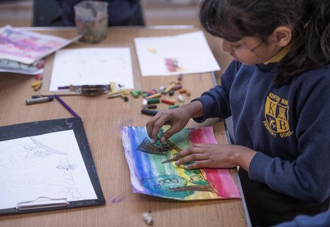 child making pastel drawing