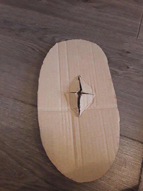 Cross shape cut in cardboard shield shape
