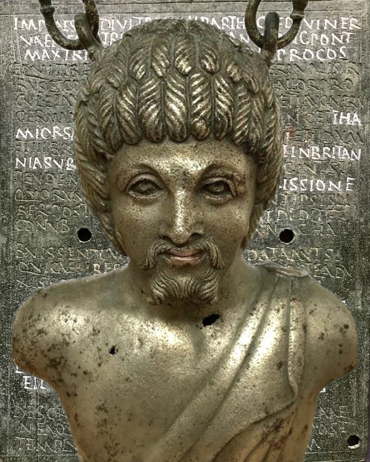 A metal vessel, designed in the shape of a male head and shoulders.