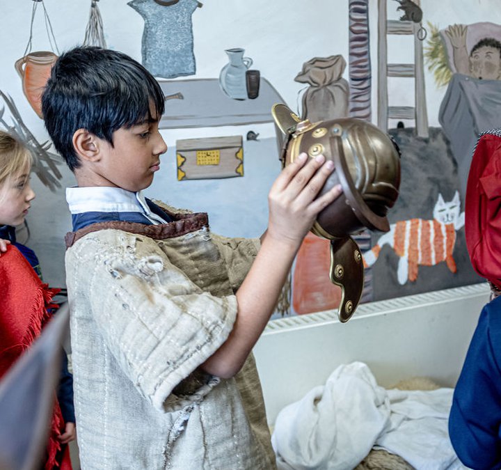 School boy holding a Roman helmet expiry 7.10.28
