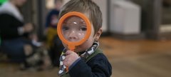 A toddler with a magnifying glass
