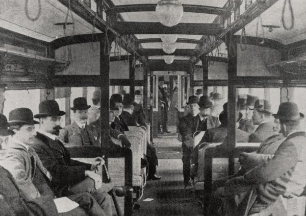 Black and white photograph of passengers on early electric train