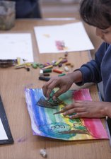 child making pastel drawing