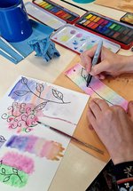 A hand watercolour painting a bookmark.