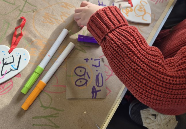 child taking part in a ceramic heart activity