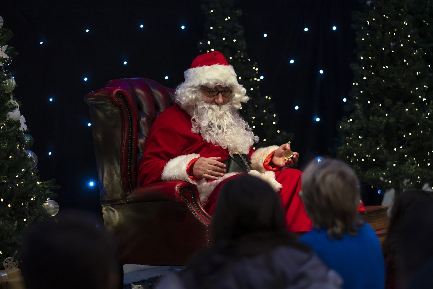 Father Christmas telling a story in his chair. Father Christmas telling a story in his chair.