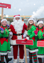 Elves and Santa smiling at the platform at Stephenson Steam Railway