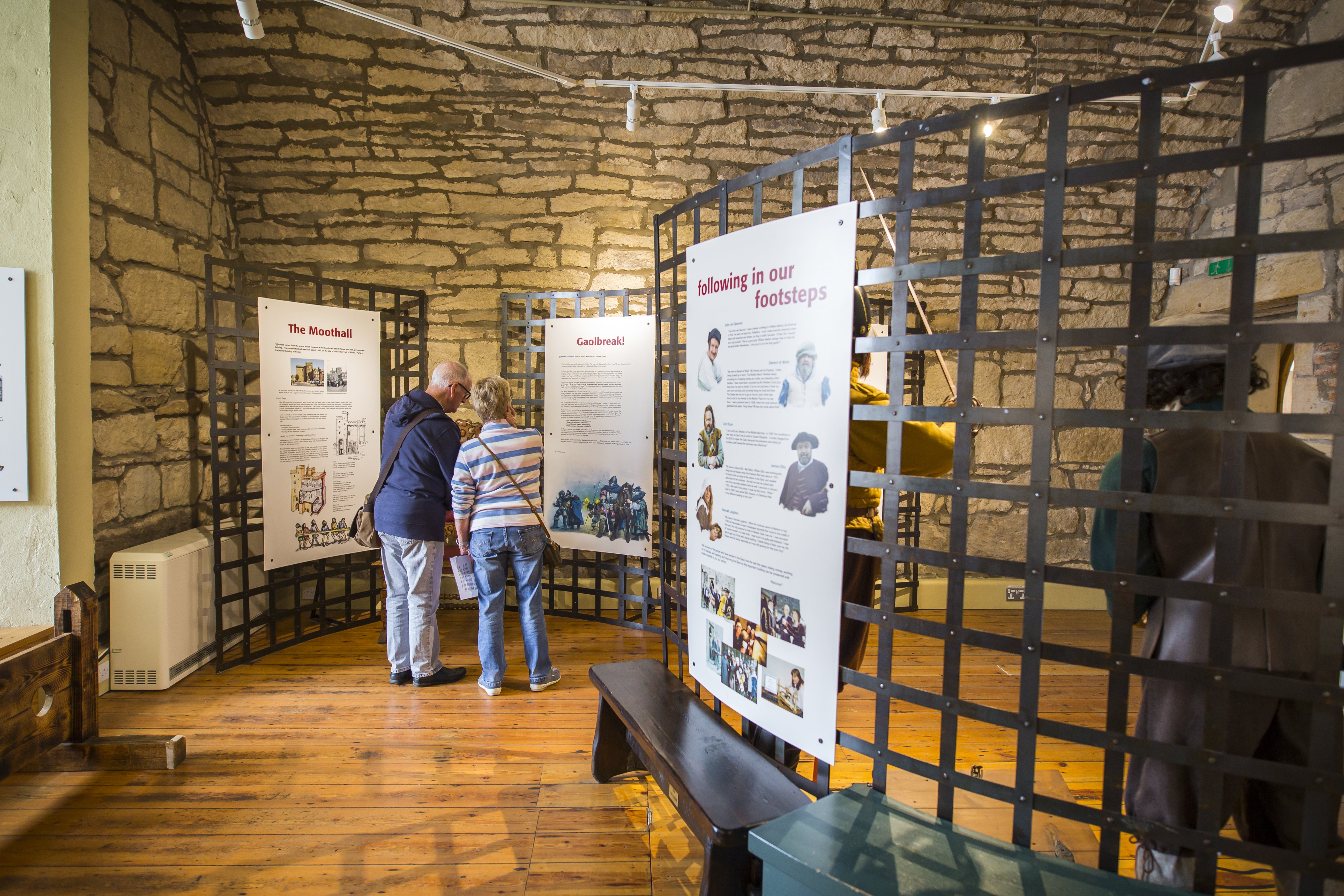 Two people look at the display in Hexham Old Gaol.