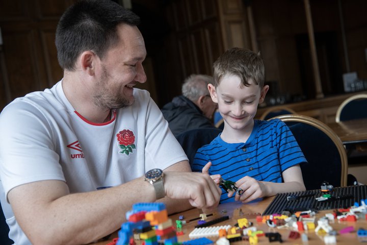A dad and son playing with construction toys