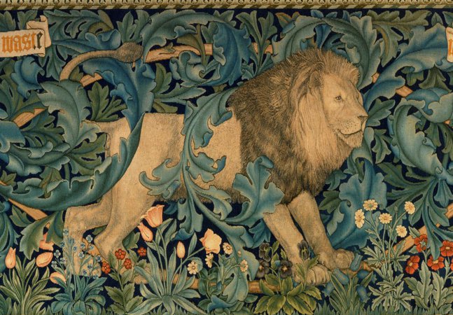 A tapestry that depicts a lion, peacock, hare, and fox.