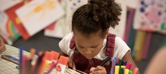 girl concentrates making a glider 