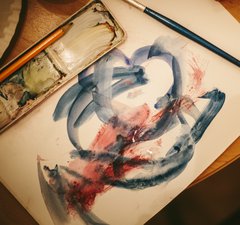 A painting of random blue and red brushstrokes and art materials