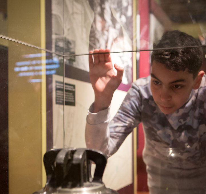 Child looking into glass cabinet