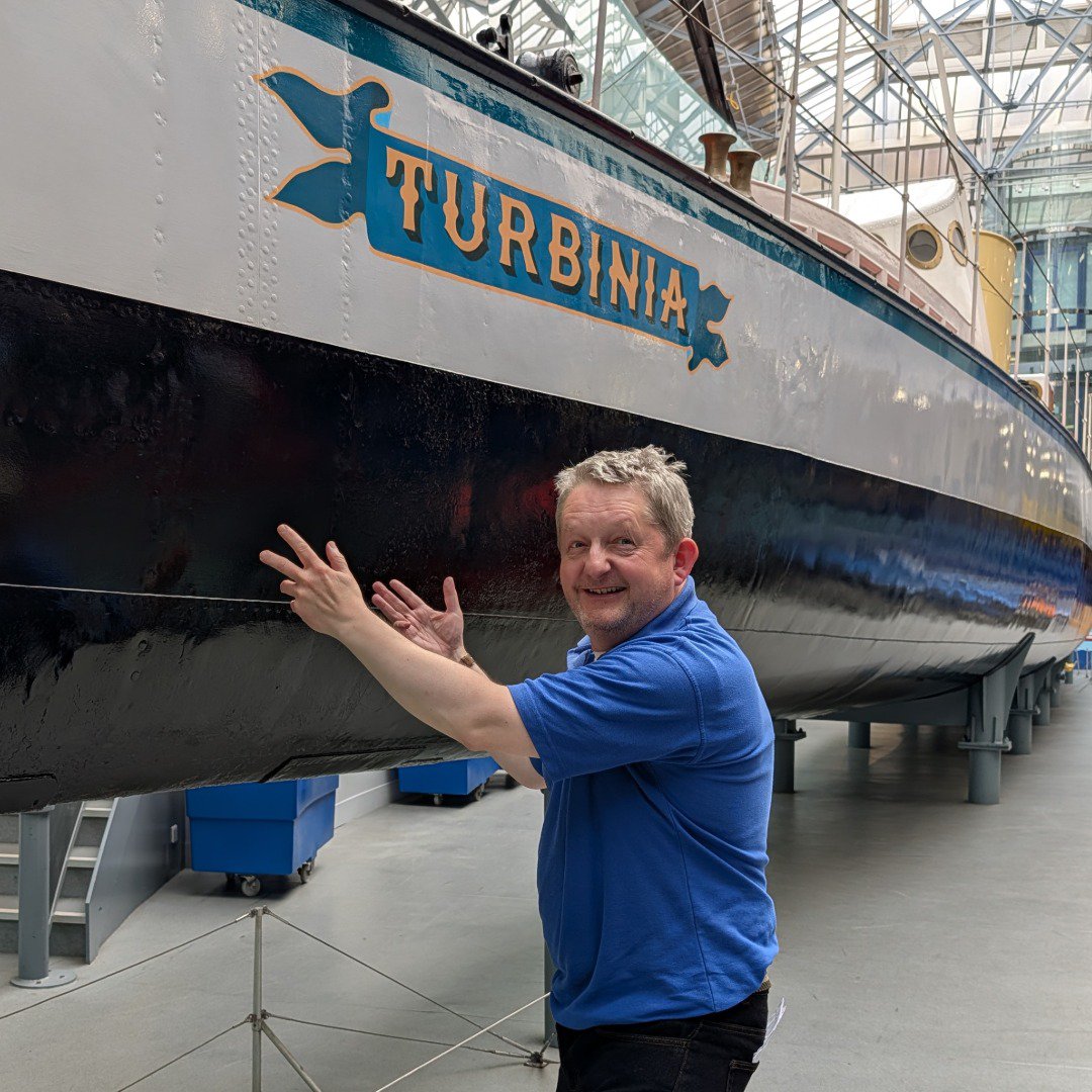 Man pointing a ship in a museum Man pointing a ship in a museum