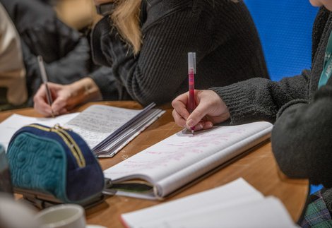 People writing on refill pads