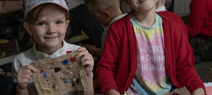Children holding up their proggy crafts