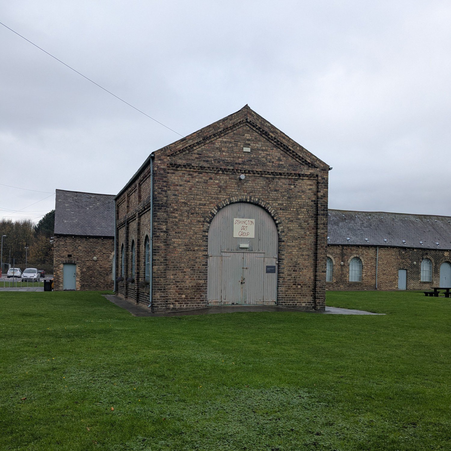 Brick building with large, arched, gated doors.