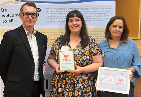 Museum staff posing with an award they have won.