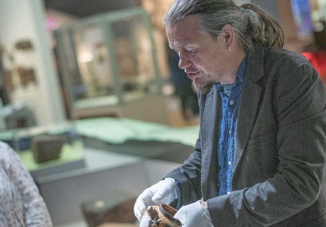 Keeper of Archaeology holding a pot