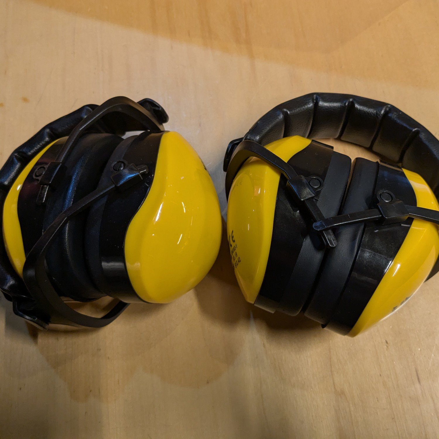 Two pairs of yellow ear defenders.