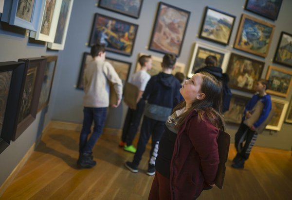 Primary school child looking at paintings