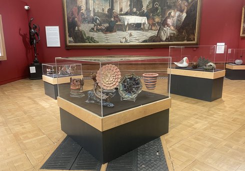 A photograph of three display cases full of ceramics 