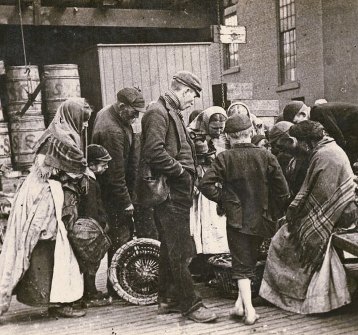 Quayside, possibly near the Fish Market, fish seller and small crowd gathered around.