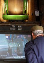 Man with hat looking at screen 
