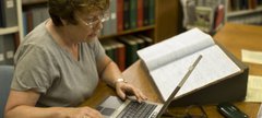 Lady using research services on laptop