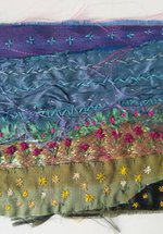 A photograph of an embroidered summer landscape.