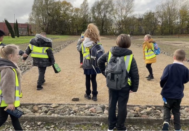 Group of school children exploring Roman fort site