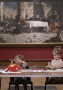 4 people sitting under tintoretto with crafts on their table