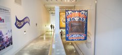 A family walks up an indoor ramp with mining banners hanging from the ceiling
