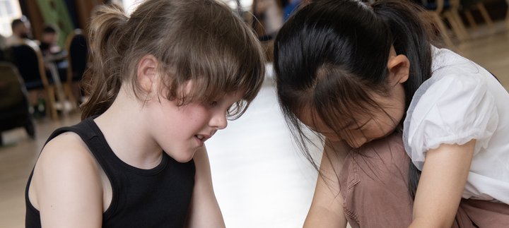 two girls working together in an event