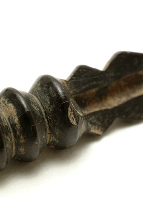 This broken jet bead reveals the hole, less than 2mm across, drilled down its length.