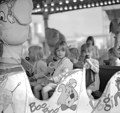 Children eating toffee apples at the Hoppings on Newcastle Town Moor, June 1973 (TWAM ref. DT.TUR/2/61856L).