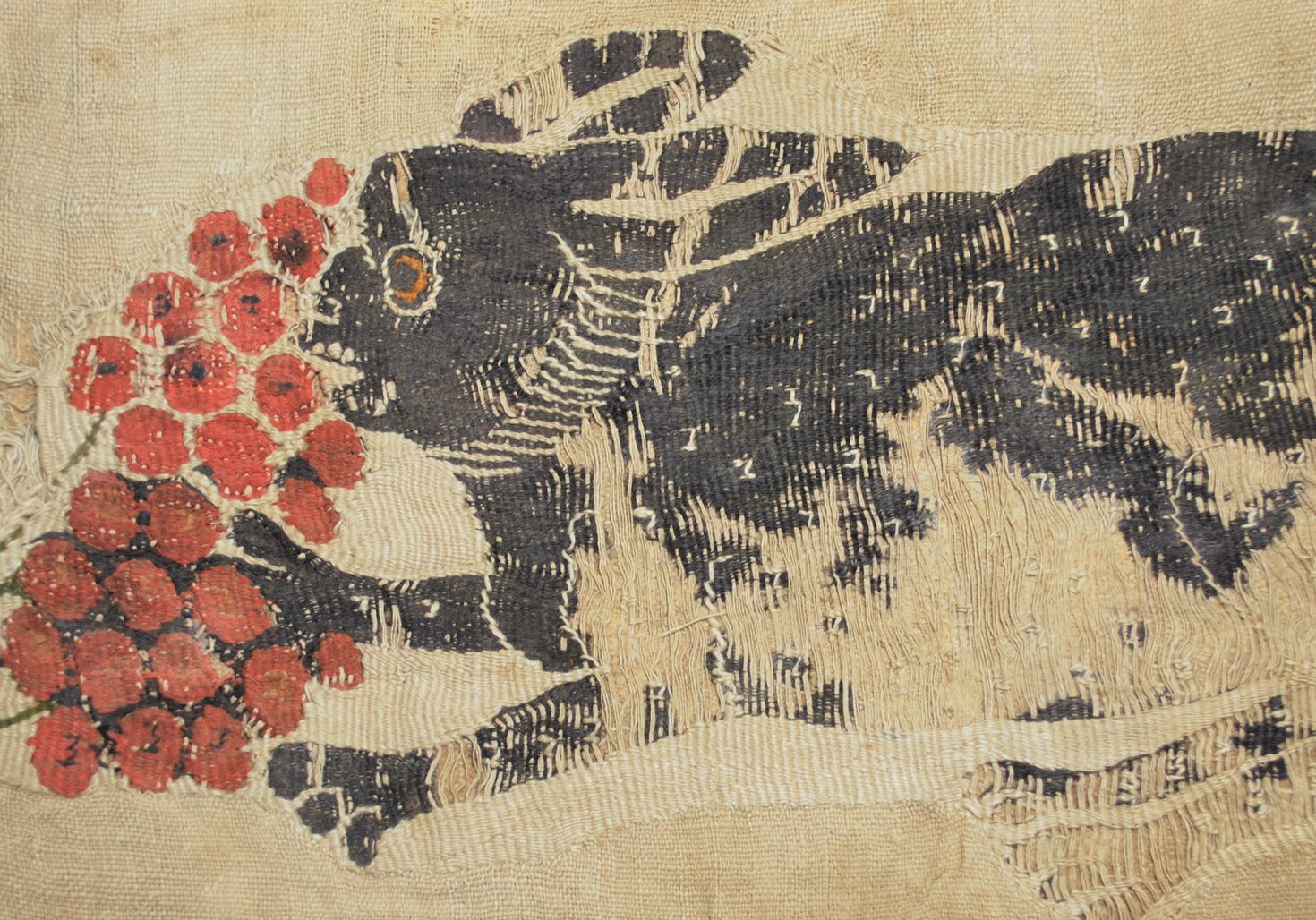 Textile showing a hare eating fruit