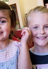 two girls aged 8 smiling 