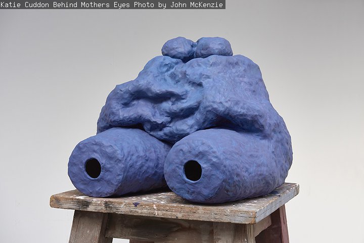 A ceramic sculpture resembling the lower part of a torso is painted blue.