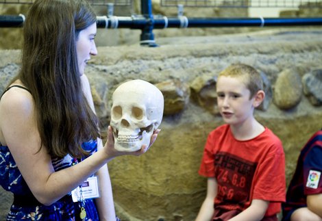 A member of the learning team at Arbeia Roman Fort with some young visitors