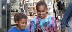 two girls giggle at entrance to museum