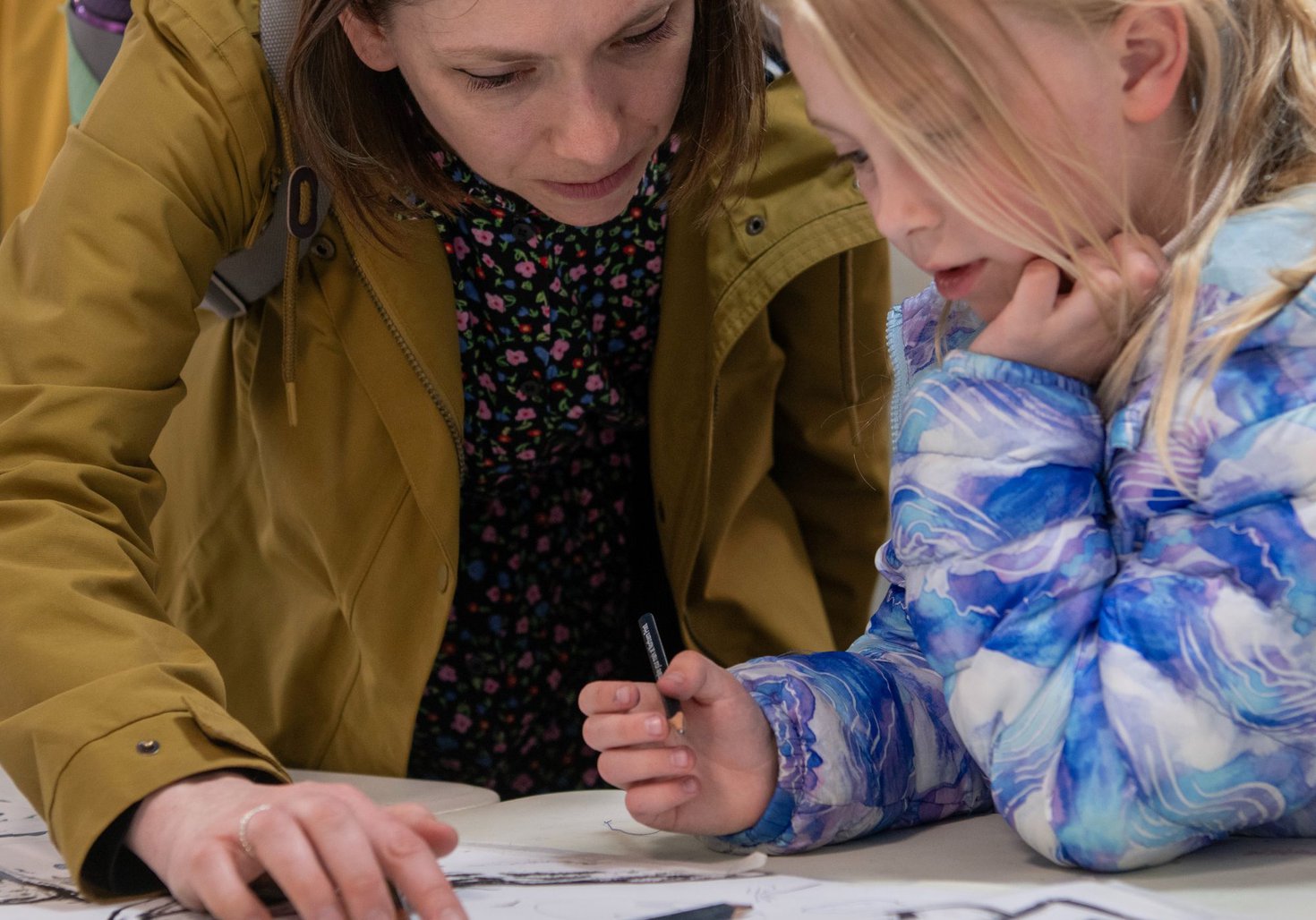 Parent and child drawing together 